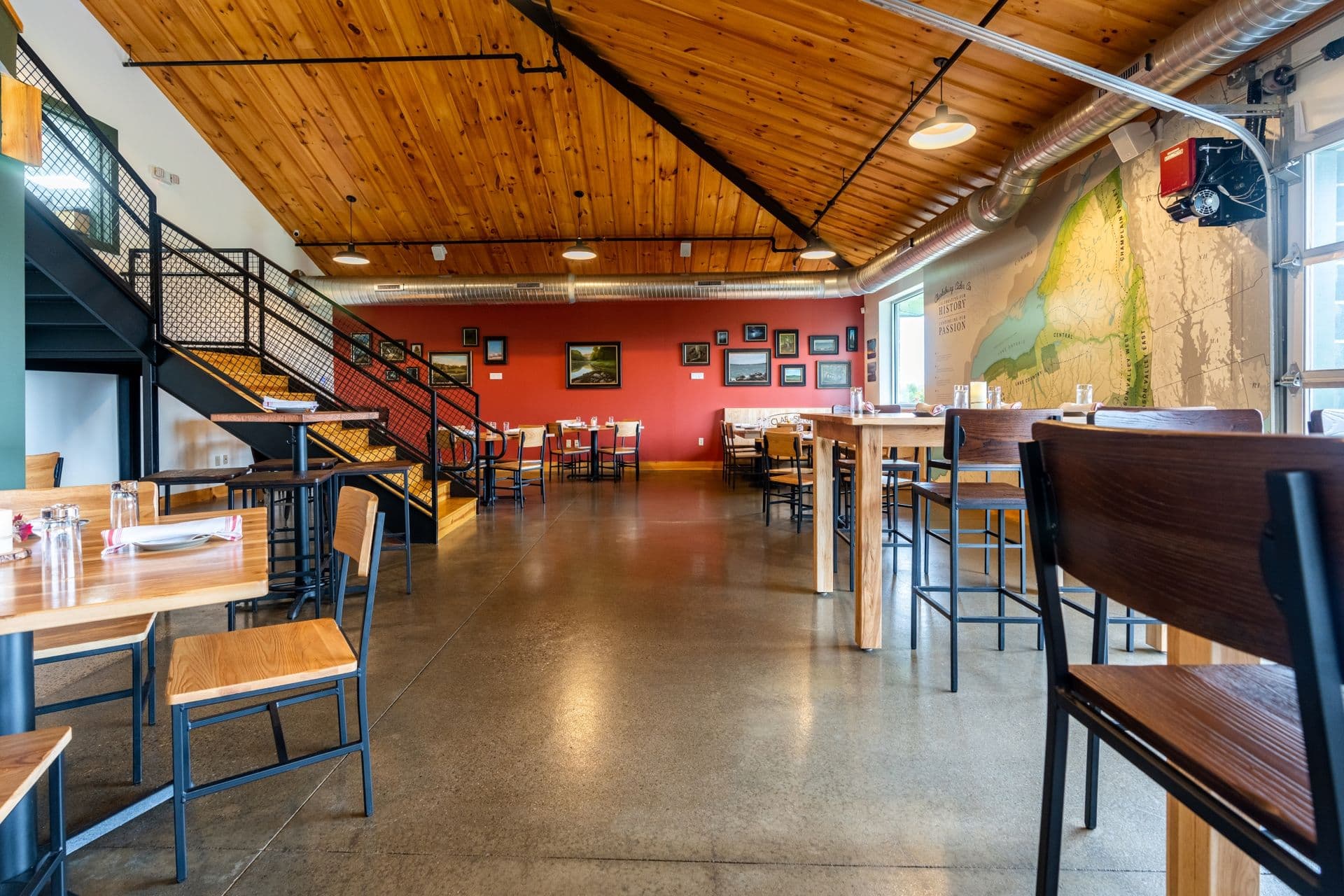 A commercial space with dining tables and chairs. The floor has a dark gray Penntek Grind and Clear finish.