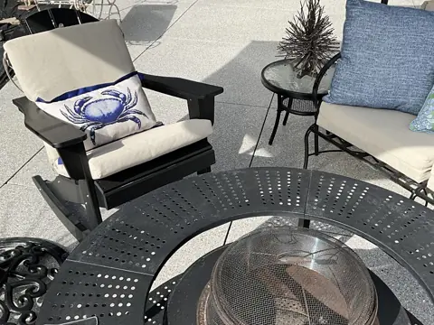 Corky M.'s coated patio with outdoor seating and a fire table.