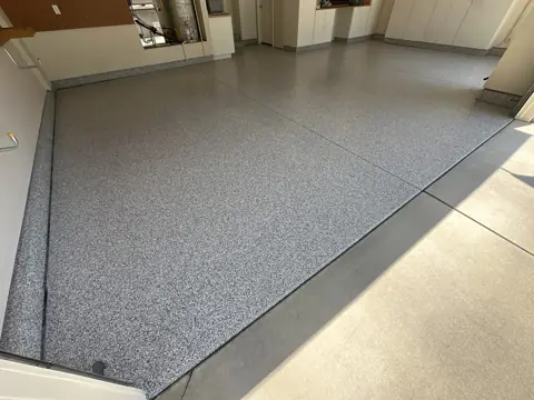 Kent Q.'s coated garage floor seen from the garage door opening.