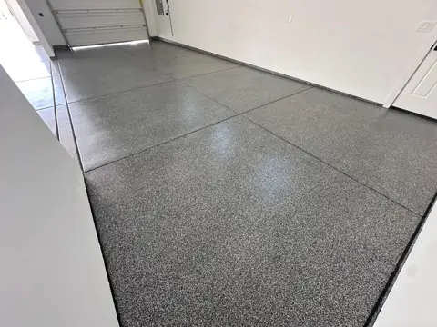 Stein J.'s large garage with a glossy dark gray flake floor.